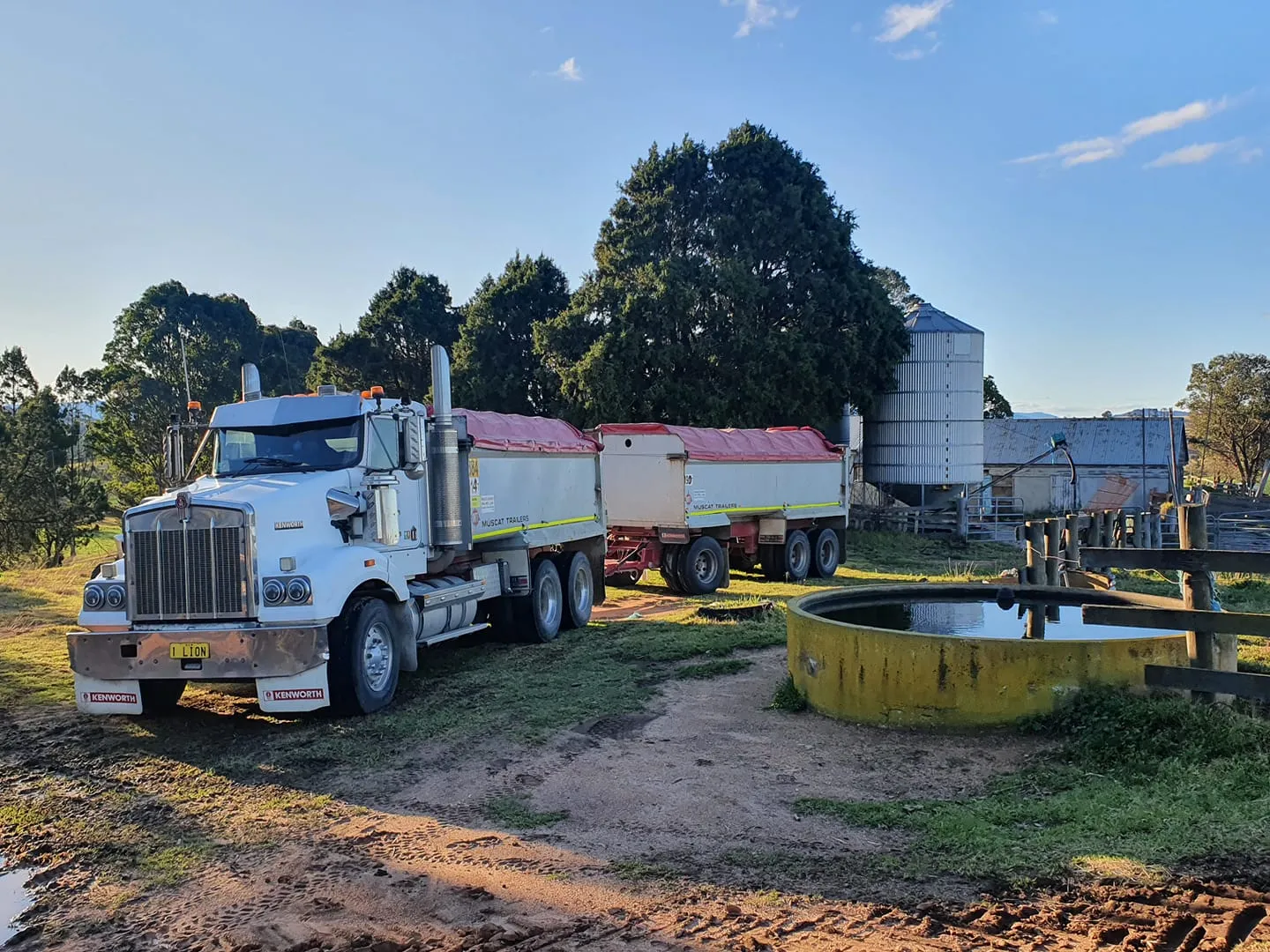 Farm truck with grain trailer on rural property